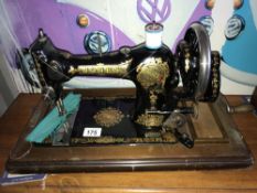 A Jones sewing machine with key and instruction booklet