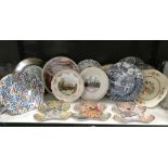 A shelf of collectors plates including Franklin Mint