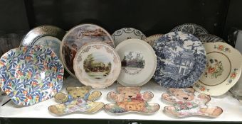 A shelf of collectors plates including Franklin Mint