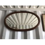 An oval framed mirror