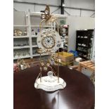 A classical design gilded metal and porcelain quartz mantle clock