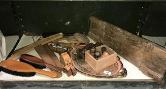 A shelf of wooden items including brushes, coat hangers etc.