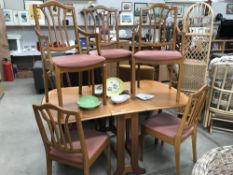 A teak drop leaf dining table and 6 chairs
