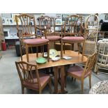 A teak drop leaf dining table and 6 chairs