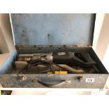 An electric jack hammer drill in metal carrying case