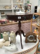 A mahogany effect drum table on tripod base
