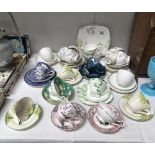 A quantity of porcelain cups and saucers