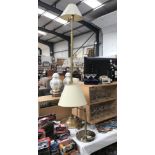 An antique brass effect standard lamp and 1 other