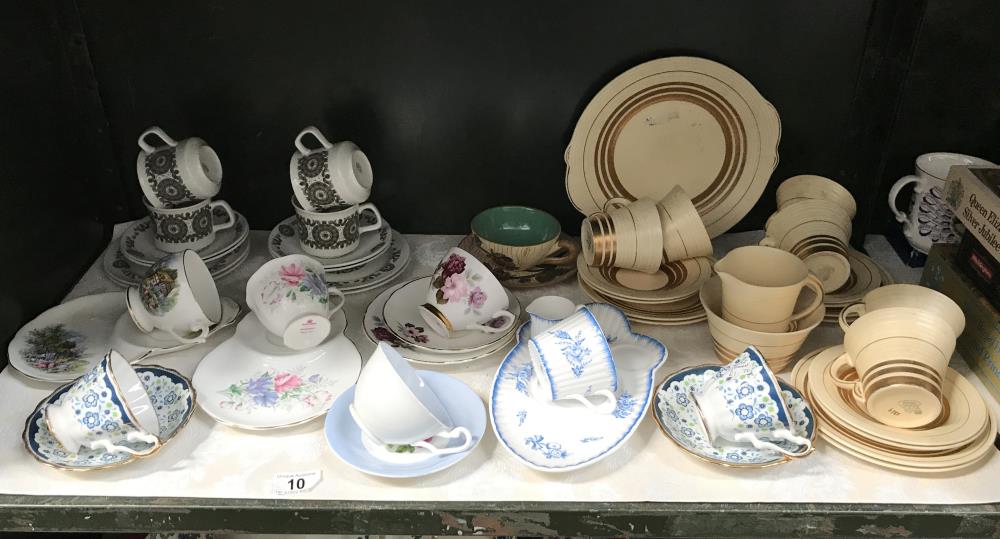 A shelf of porcelain tea ware including Royal Albert