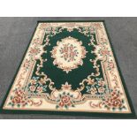 A green and cream patterned rug (92" X 67")