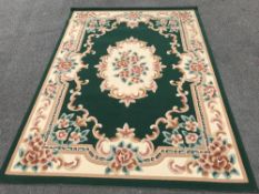 A green and cream patterned rug (92" X 67")