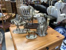 A brass horse with jockey, another brass horse,