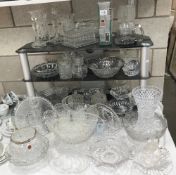 A large quantity of crystal, cut and moulded glass including vases, candle sticks etc.