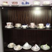 3 shelves of porcelain tea cups and saucers including trios