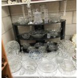 A large quantity of cut and moulded glass including cube glass bowl etc.