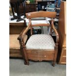 An Edwardian mahogany carver chair commode