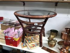 A bamboo glass topped conservatory table