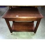 A mahogany table on castors