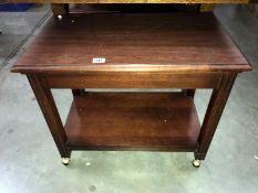 A mahogany table on castors