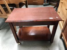 A darkwood stained tea trolley