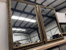 A pair of large gilt framed mirrors
