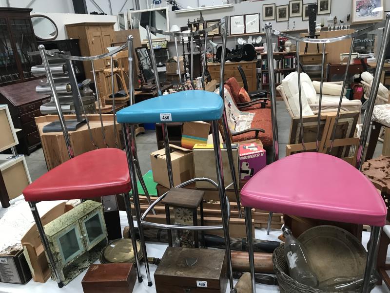 A pair of chrome chairs and a chrome bar stool