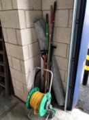 A quantity of garden tools including hose pipe