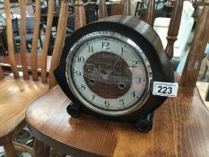 A teak drop shape wooden mantel clock with key and pendulum