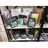 2 shelves of assorted photo frames