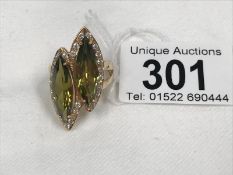 A gold ring marked 14ct but tests as 18ct set 2 large green stones and small white stones size P