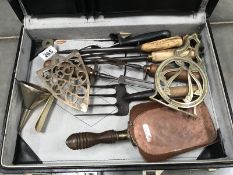 A case of old kitchen tools, funnel trivets, copper shovel etc.