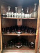 3 shelves of red and clear glassware