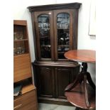 A Victorian mahogany glazed top corner cabinet