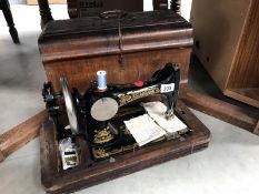 A cased Frister & Rossman sewing machine