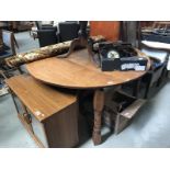 A large oak circular drop leaf table