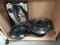 A New wok and a lidded frying pan