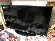 A Samsung flat screen TV on stand in working order (has remote)