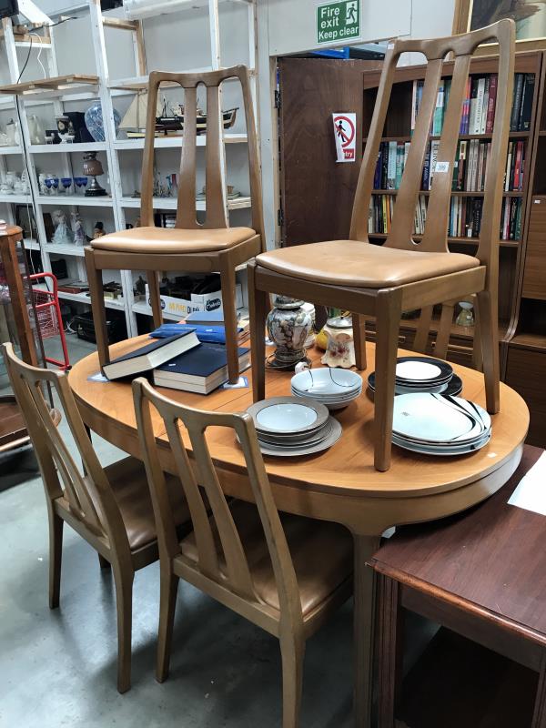 A teak extending dining table and 6 chairs