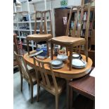 A teak extending dining table and 6 chairs