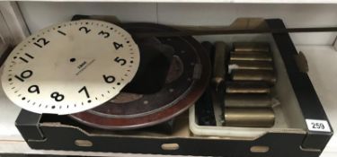 A selection of brass regulator weight, an IBM international clock face etc.