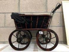 A wood and metal dolls pram