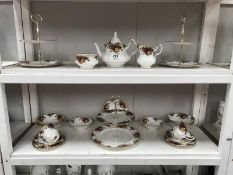 2 shelves of Royal Albert Old Country Roses including cake stands, teapot etc.