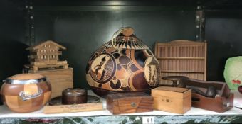 A shelf of wooden items including money boxes etc.