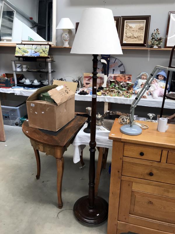 A wooden standard lamp with stand