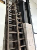 A quantity of wooden ladders