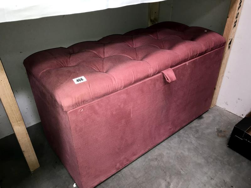 A pink dralon ottoman