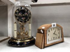 An Art Deco 8 day clock and anniversary clock under dome