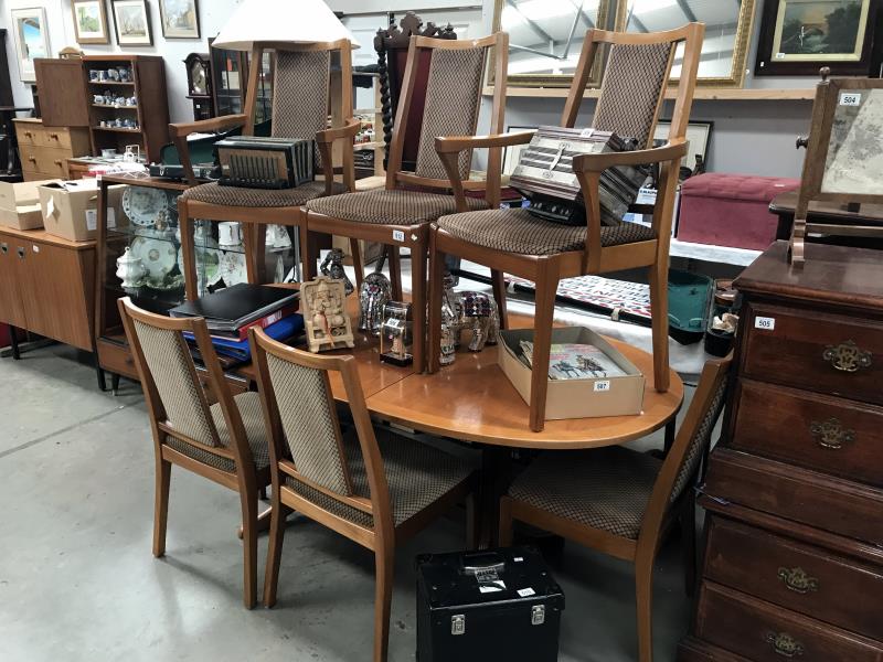 A teak extending dining table and 6 chairs