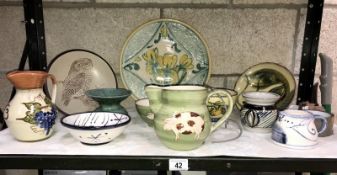 A shelf of studio pottery