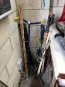 A quantity of garden tools, canes etc.